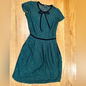 Green lace dress with velvet accents.